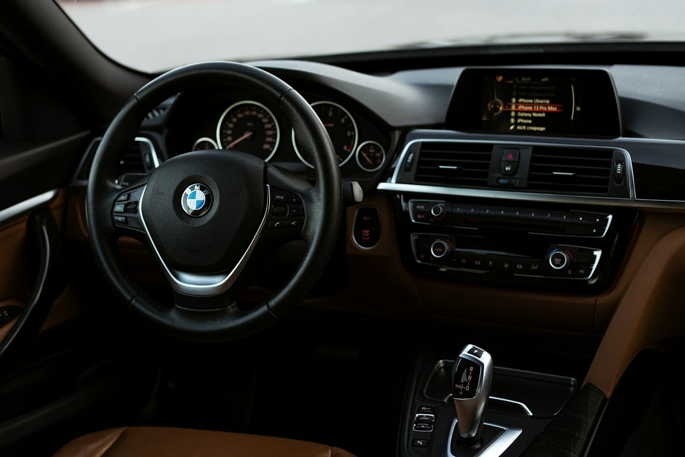 BMW cabin with steering wheel, dashboard and driver controls